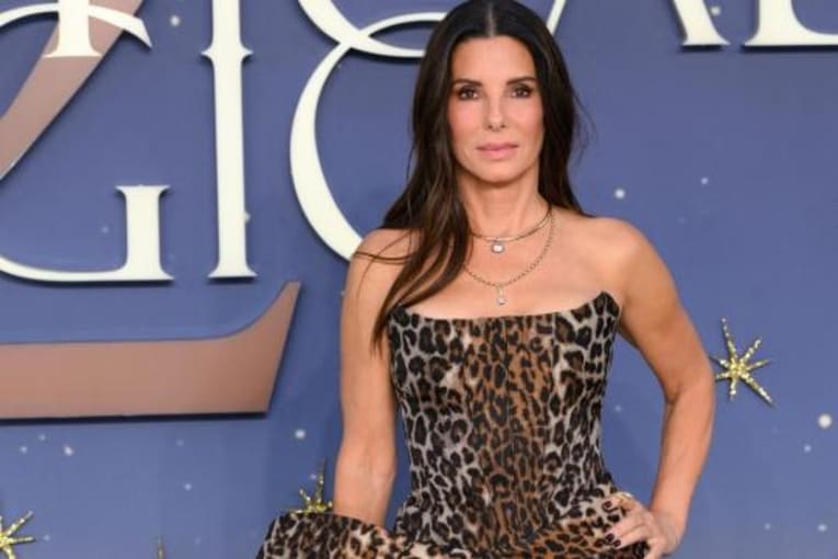 Sandra Bullock's Givenchy leopard print dress features a thigh-high slit at 'Practical Magic 2' premiere
