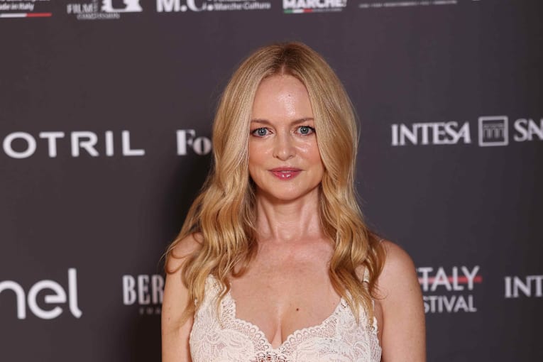 Heather Graham, 56, sunbathes in a hot pink bikini on beach in Greece