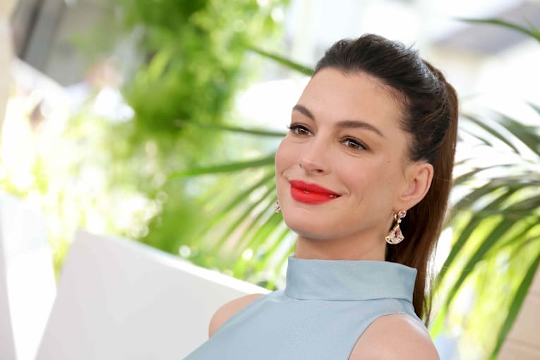 Anne Hathaway turns heads in a divisive, bump-baring top paired with low-rise jeans