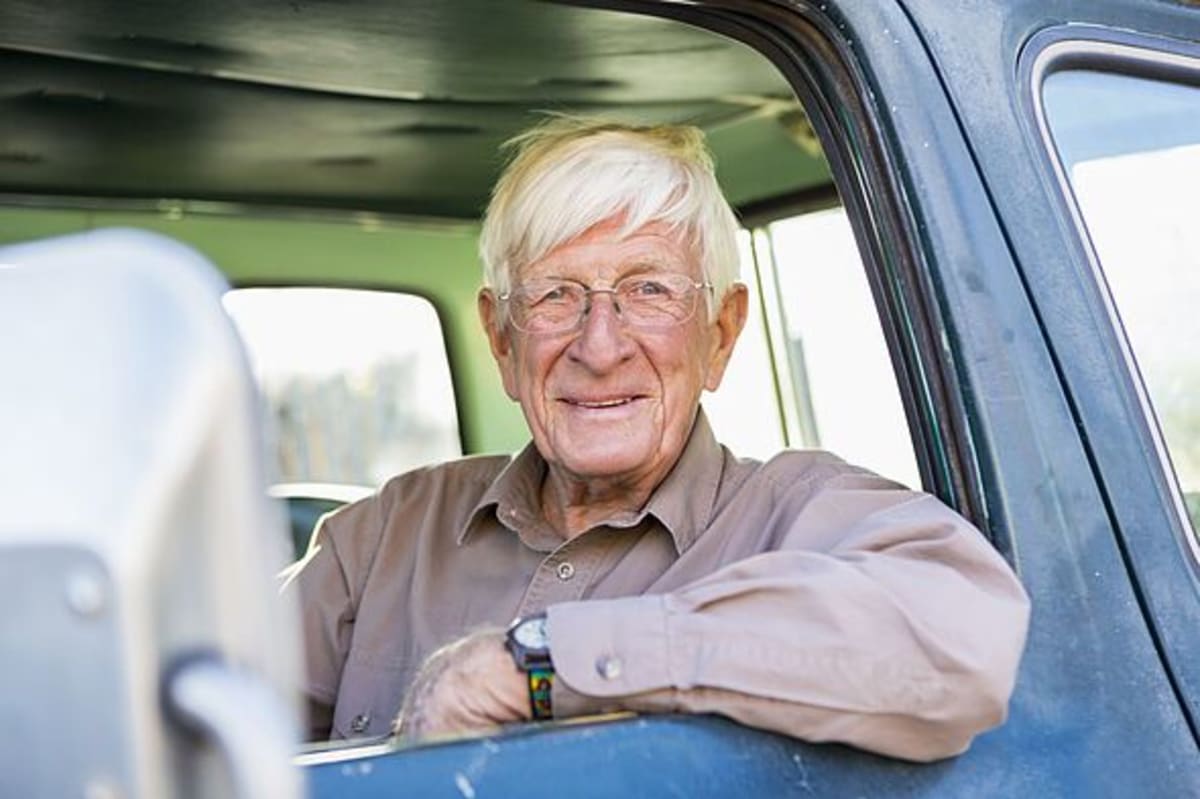 Older man sitting in truck
