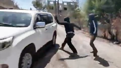 Palestinian woman and NBC News team attacked by masked Israeli settlers in West Bank