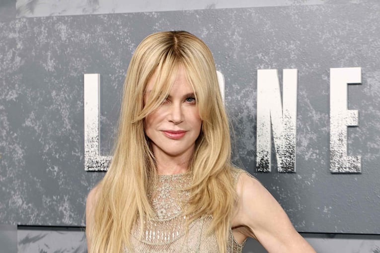 Nicole Kidman radiates while reviving her natural red curls in a silk dress blooming with florals