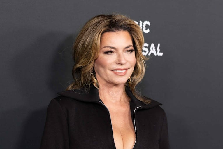 Shania Twain, 60, bares her bra in a sheer black lace bodysuit on stage and feels 'gorgeous and confident'