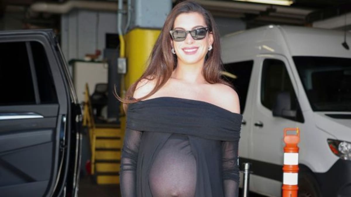 New Photo - Anne Hathaway’s Fully Sheer Black Top Reveals Her Baby Bump in NYC