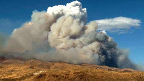 Firefighters are trying to stop a fast-moving Nevada wildfire from spreading to homes in Reno