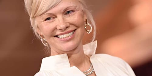 Pamela Anderson radiates in a strapless butter yellow swimsuit while enjoying a 59th birthday swim