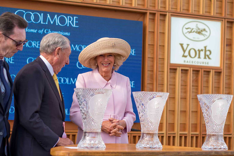 Queen Camilla pins her 'lucky charm' brooch in a unique location for a day of horse racing