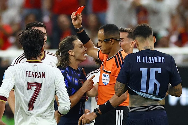 Uruguay's Agustín Canobbio held back from referee after red card in chaotic World Cup loss