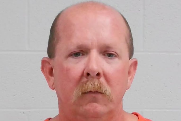 Fire chief charged with murder 1 year after wife was fatally shot, as police uncover chilling phone messages and videos