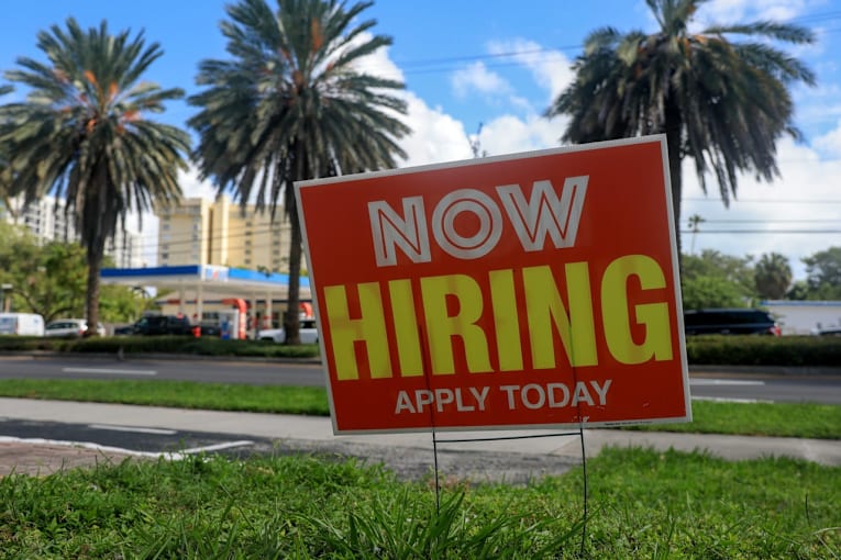 US jobless claims slip to 203,000 as layoffs remain low