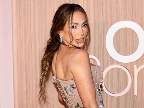 Jennifer Lopez wears dramatic black dress and dazzling bling to Taylor-Travis wedding