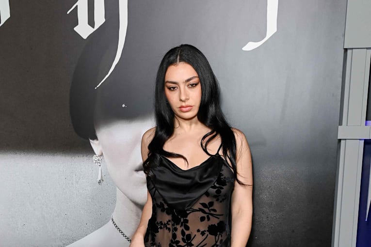 Charli XCX embraces gothic glamour in a plunging corset LBD covered in sheer cutouts
