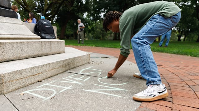 Protestors chalk on campus against Ohio State’s partnership with Anduril and the university chalk ban
