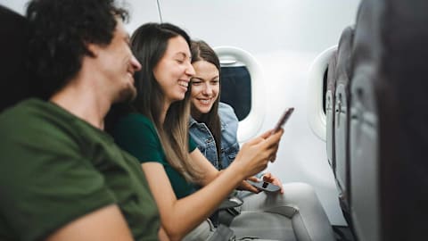 This is the easiest way to stop a chatty seatmate on a flight without being rude, according to an etiquette expert